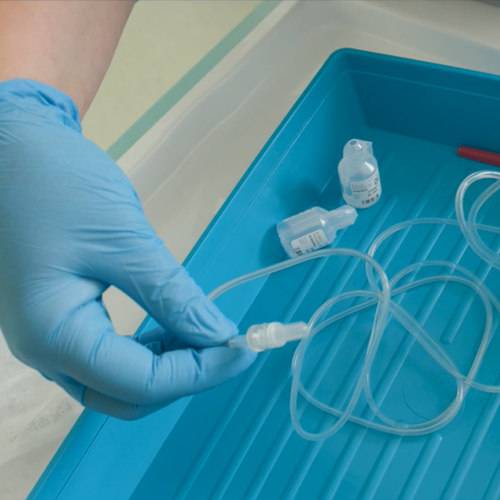 Medical fluids being pushed through a needle and tube.